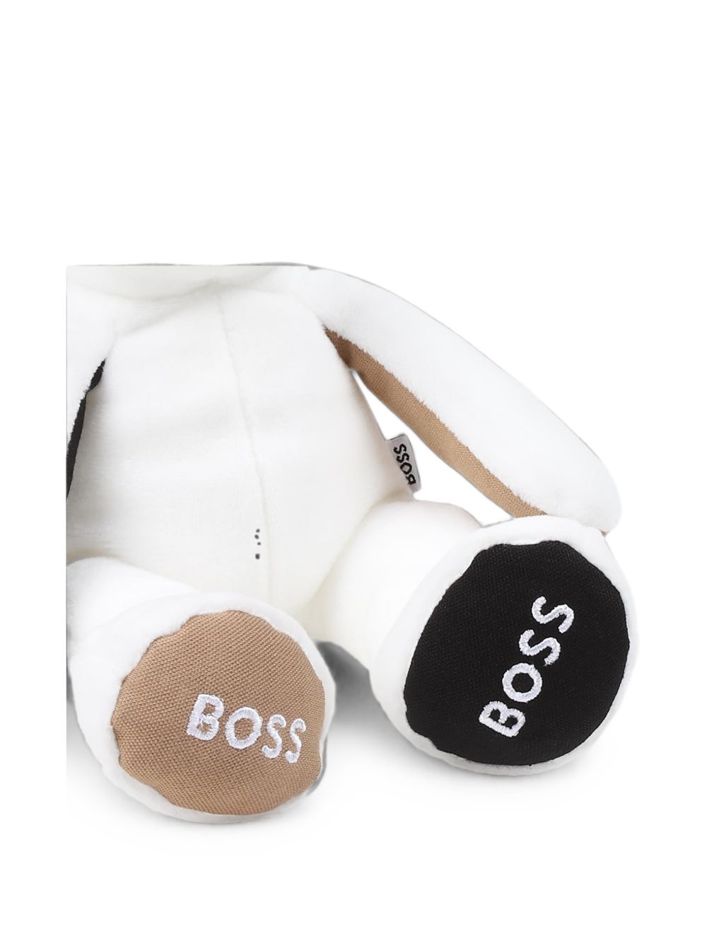 Polyester eco-pelliccia cuddly toy, branded embroideries under feet, branded woven label sul retro. Dimensions : 40 cm length (standing position e ears up) 17 cm height (sitting position e ears down). Sold in a zipped pouch J51013 10P BOSS KIDSWEAR