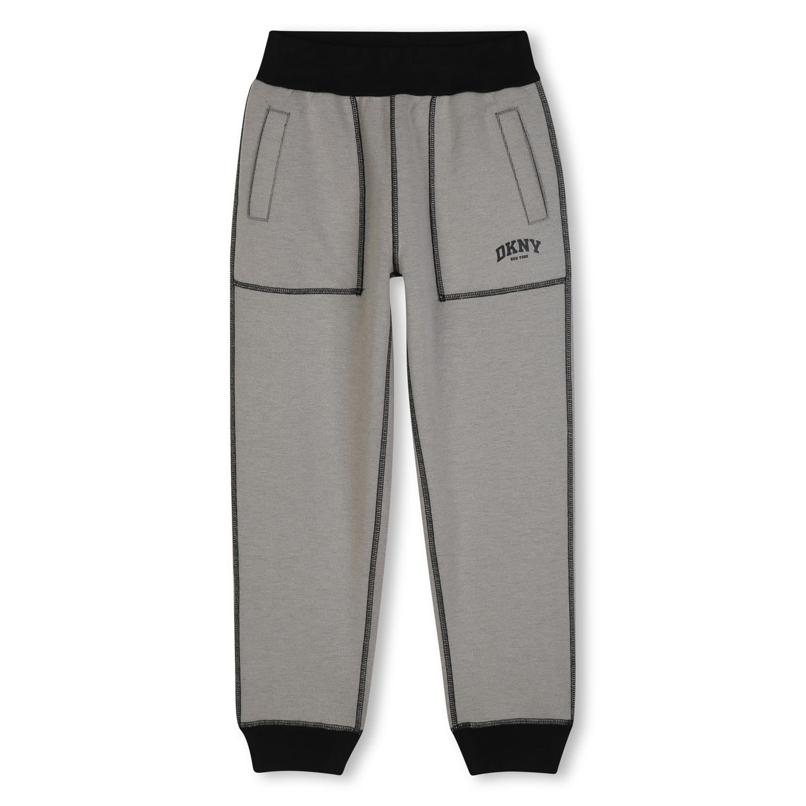 Reversible pantaloni in doble jersey, 86% polyester 10% viscose 4% elastane. One black side in jersey piqué effect con tasche e printed dkny logo. Other side in beige jersey con davanti tasche e printed dkny logo. D62866 P90 DKNY KIDS