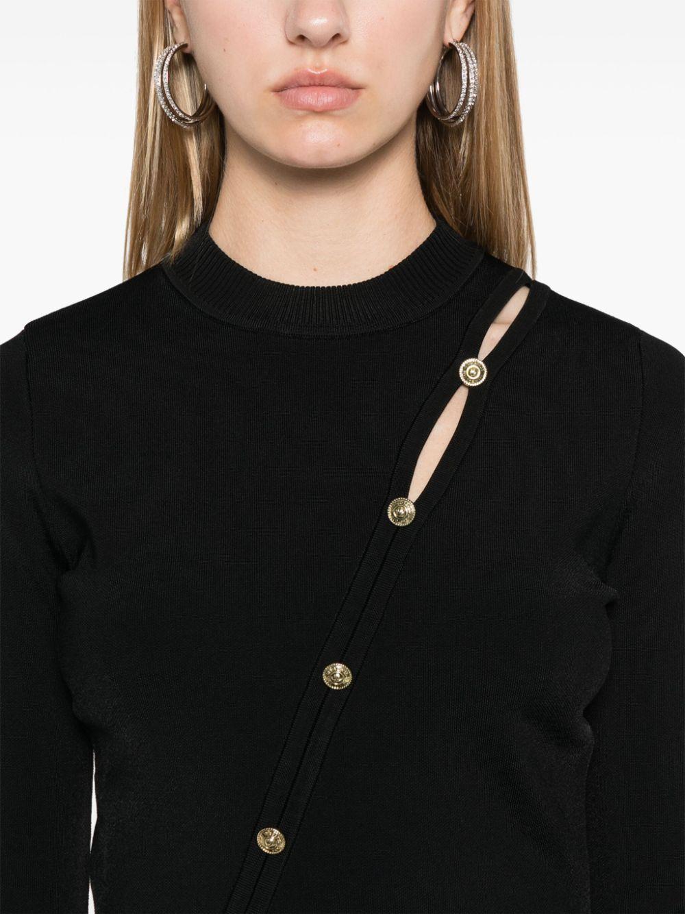 Maglia nera bottoni obliqui frontali