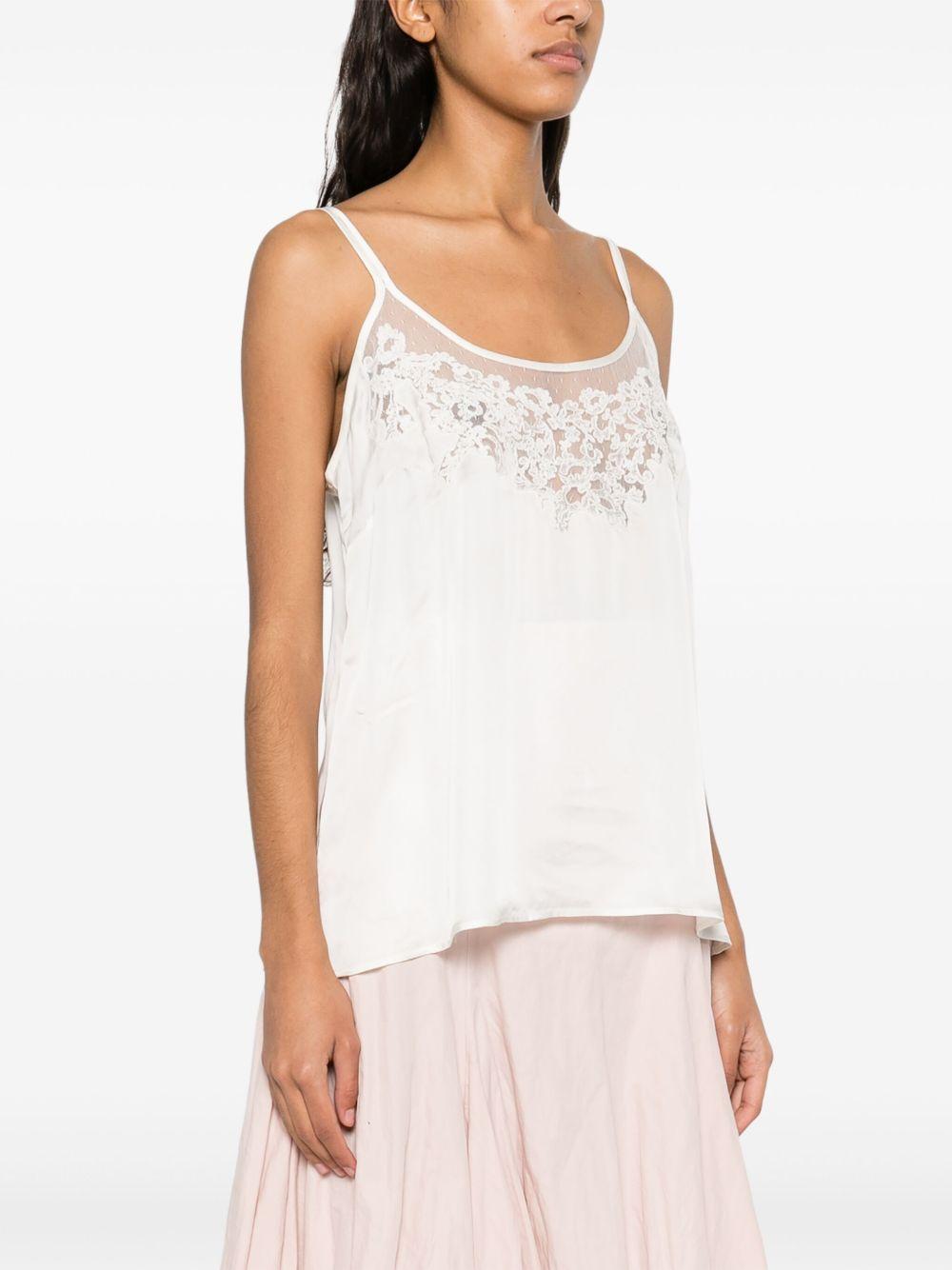 Top bianco con ricami e trasparenze
