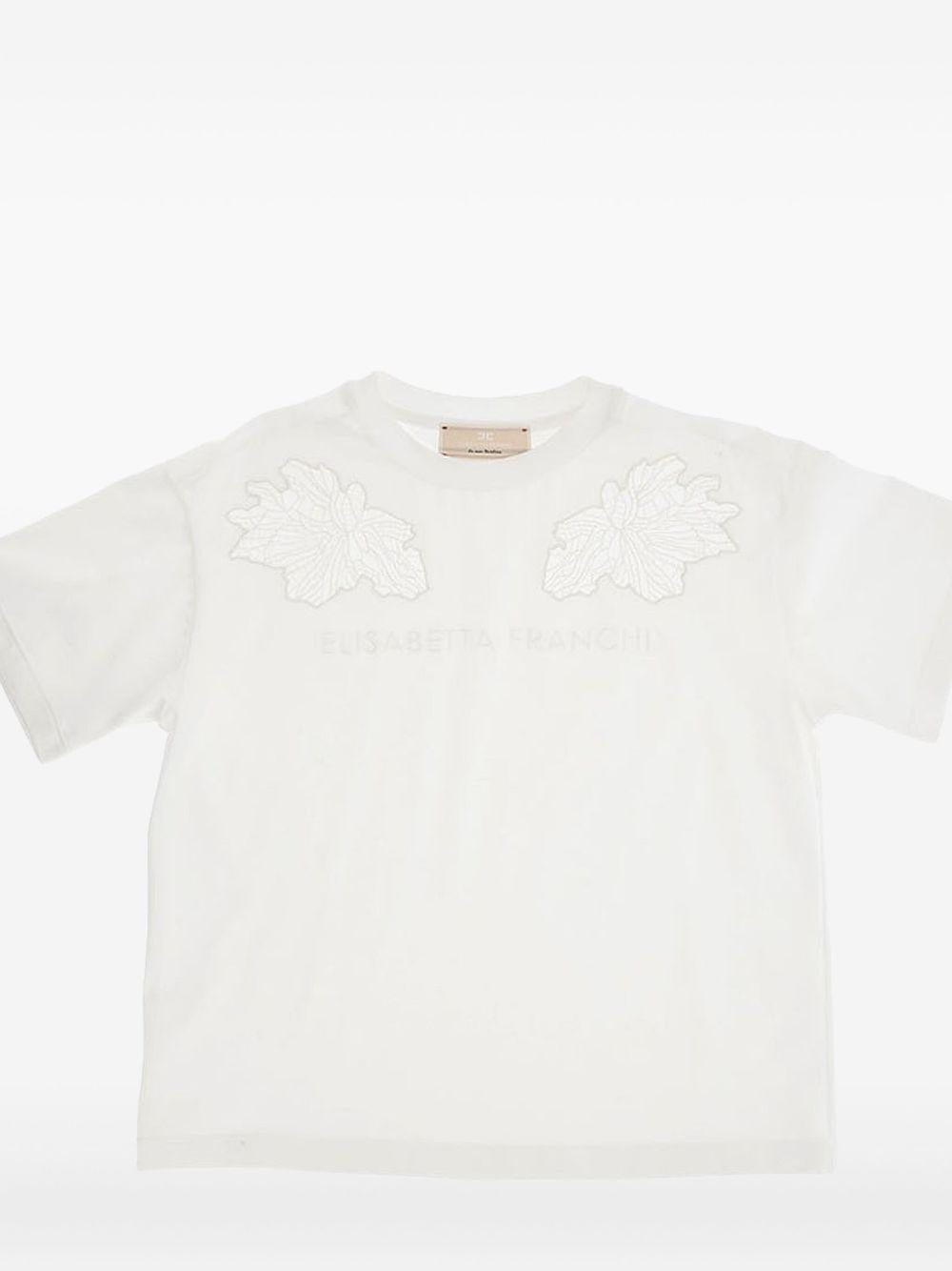 T-shirt panna con ricami floreali velati spalle