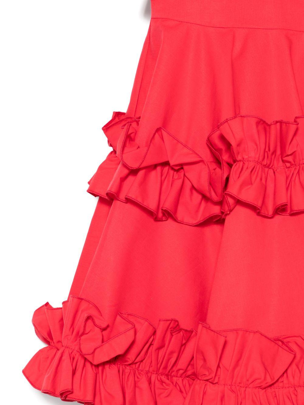 Abito rosso con balze e ruches
