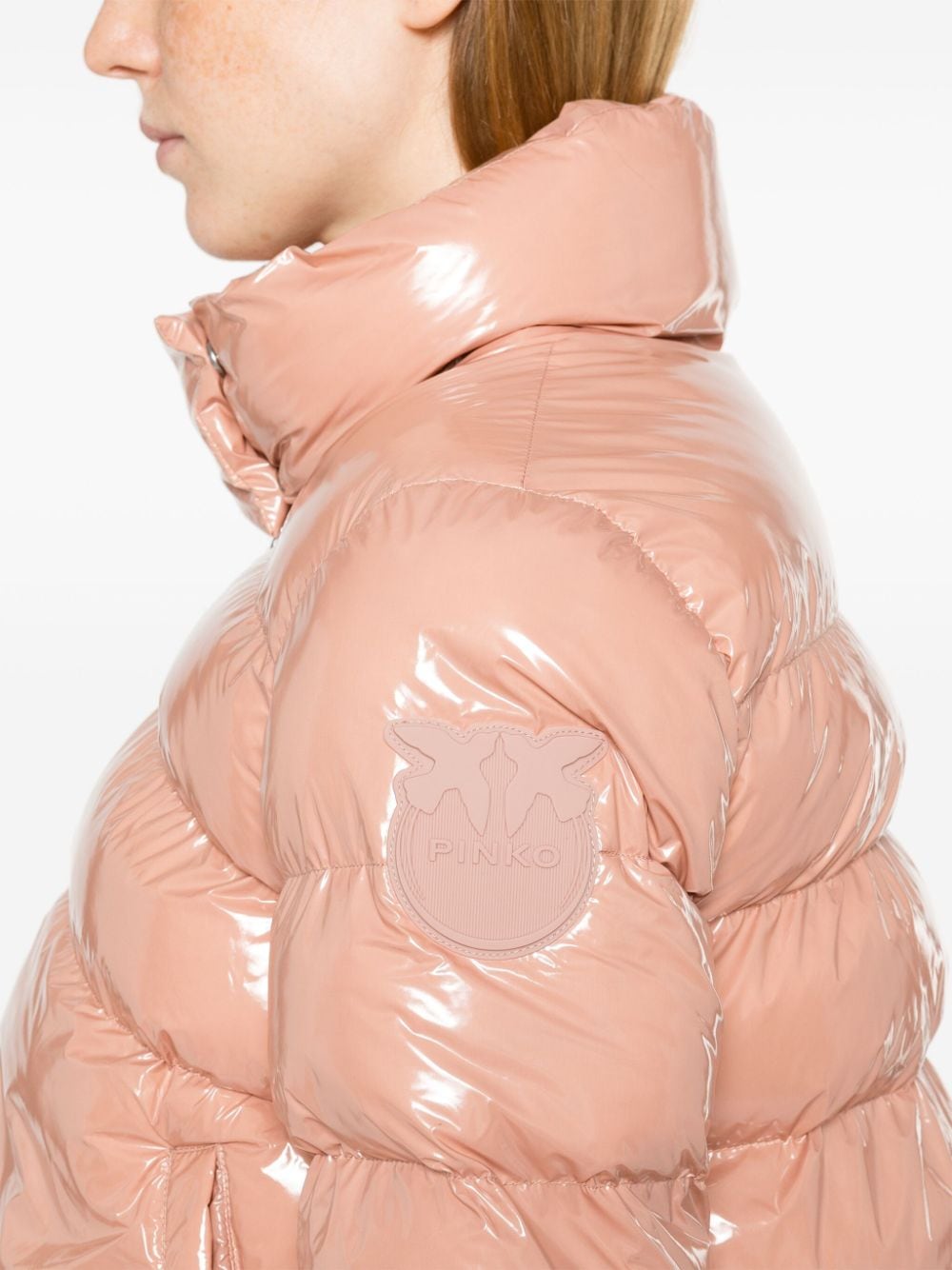 Padded peach jacket with patent effect