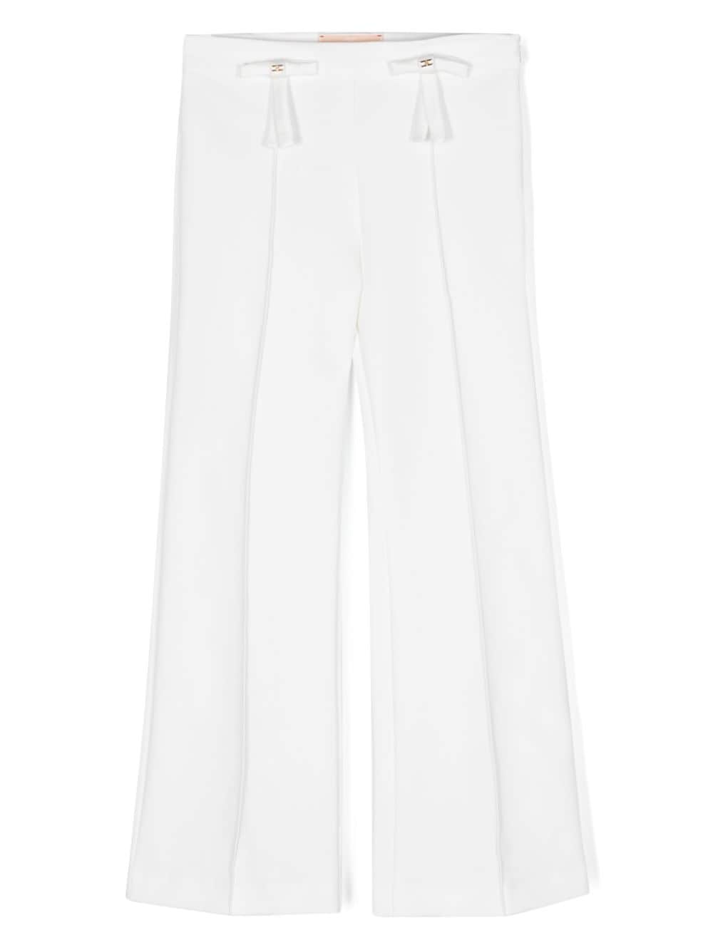 White trousers with front bows