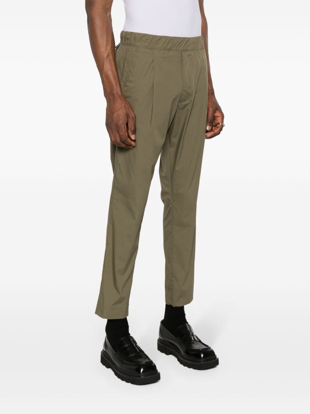 Green tapered trousers