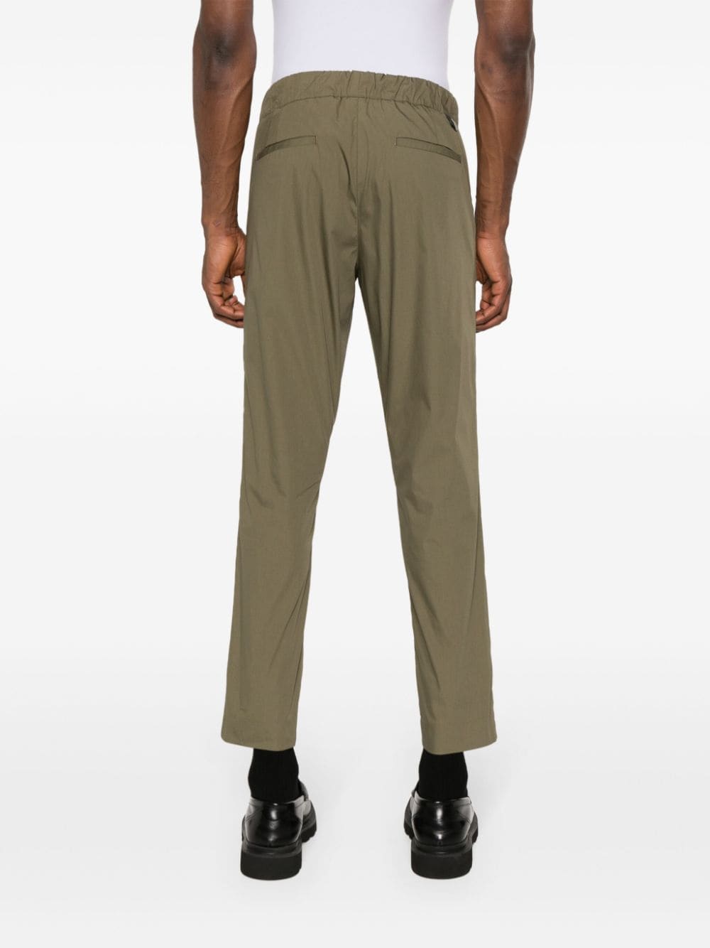 Green tapered trousers