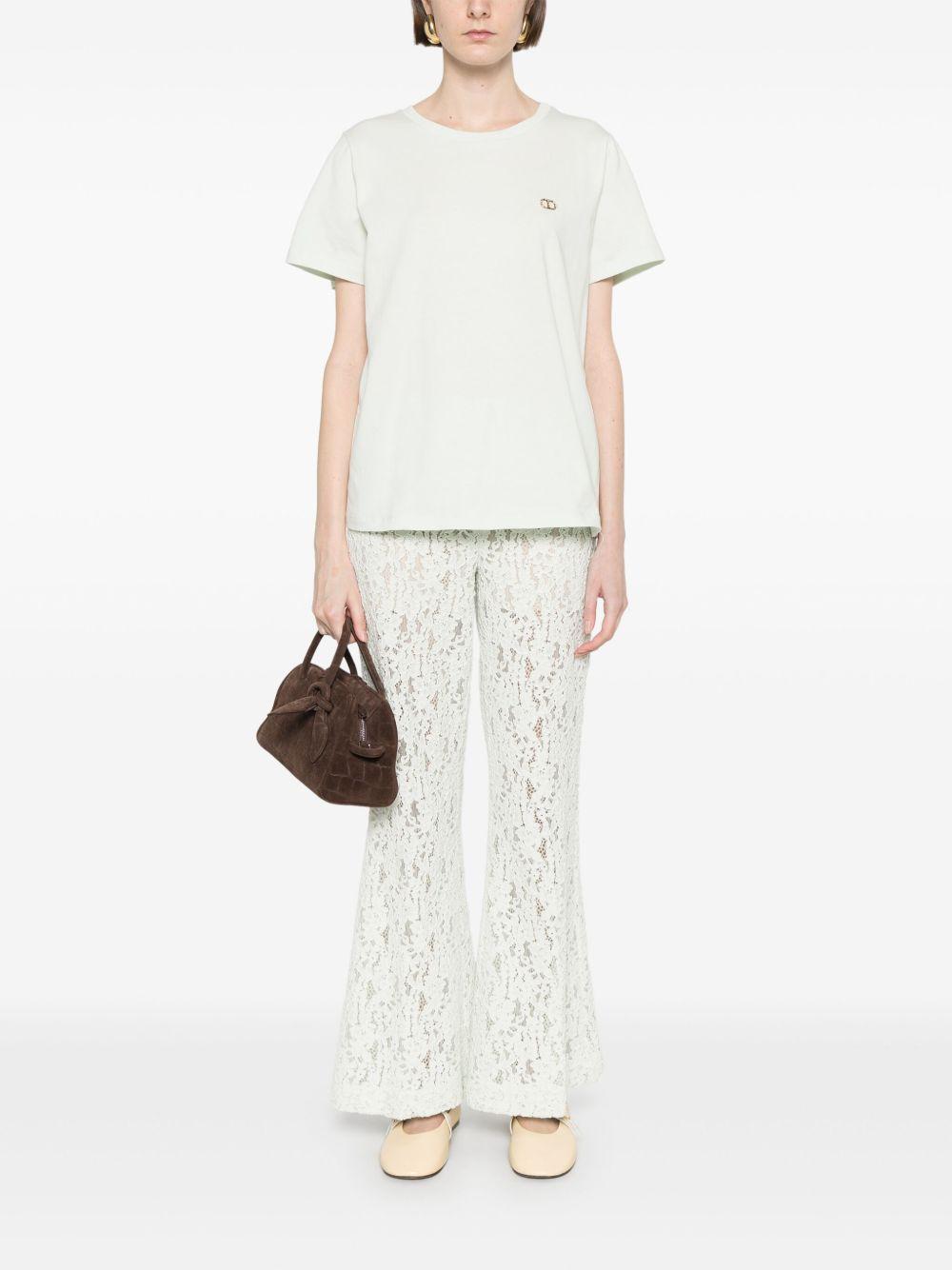 Pantaloni flare in pizzo floreale verde acqua
