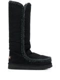 Black round toe boots with logo patch