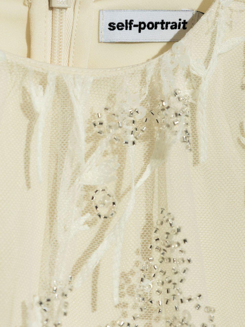 Abito crema in tulle e macramè