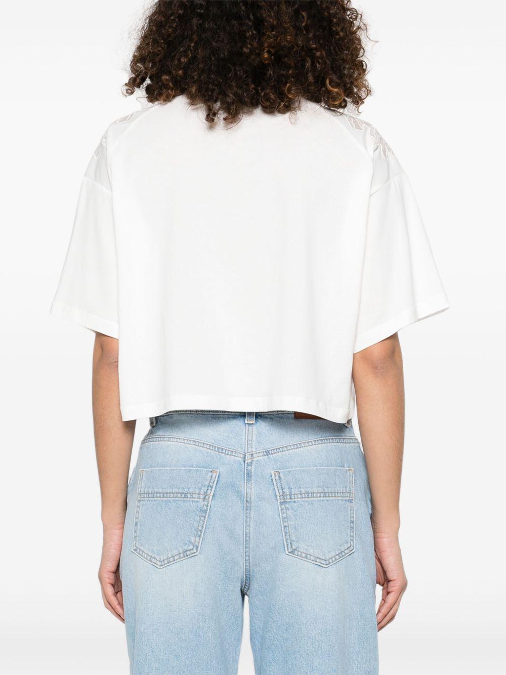 T-shirt bianca con ricami semitrasparenti e logo