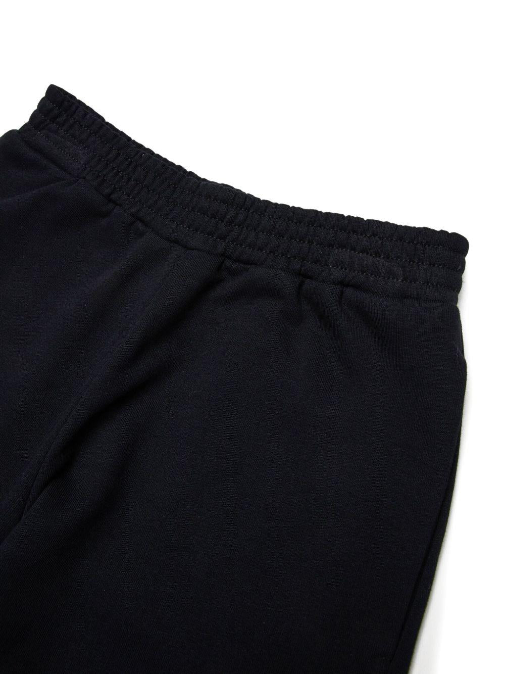 Pantaloni neri sportivi con motivo numeri e vita elasticizzata M60895MM02X M6900 MM6 MAISON MARGIELA KIDS 