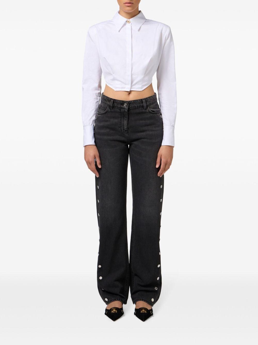 Jeans a gamba ampia nero con bottoni laterali